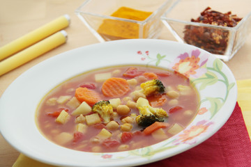 Spicy chickpeas soup with carrot, celery, broccoli, turmeric and chili peppers. 