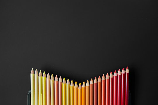 Colour pencils isolated on black background close up
