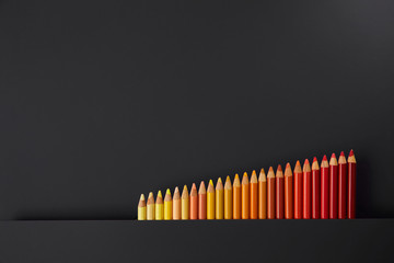 Colour pencils isolated on black background close up
