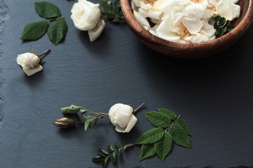 white roses on black stone background