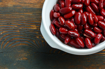 Healthy Benefits of Red beans.
Red beans in white bowl on wooden background.