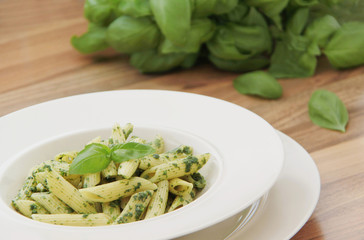 Penne pasta with spinach pesto. Close up view.
