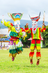 Obraz na płótnie Canvas Ghost mask and costume colorful Phi Ta Khon festival on June Young people dress in spirit and wear a mask, sing and dance at Loei province Thailand.