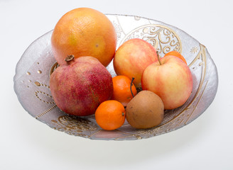 mix fresh fruits on plate isolated on white
