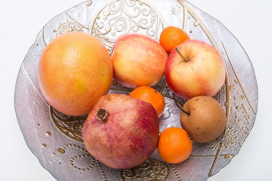 mix fresh fruits on plate isolated on white