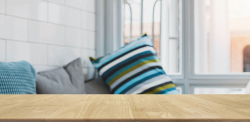 Wood table top and blurred bokeh cafe and coffee shop interior background with vintage filter - can used for display or montage your products.