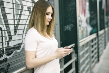 Fototapeta na wymiar young woman using smart phone outdoors