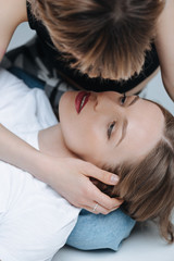 Fototapeta premium Close-up portrait of sensual young lesbian couple hugging and looking at each other