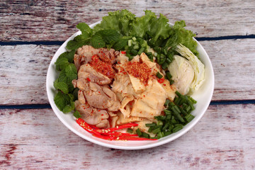 Spicy sour mixed vegetable salad with chicken and bamboo shoots.