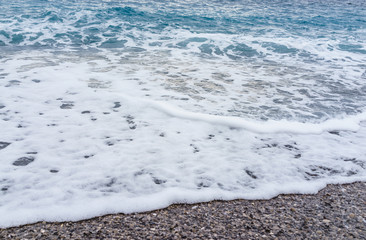 selective focus Soft gentle waves with foam in blue ocean italy shore summer vacation