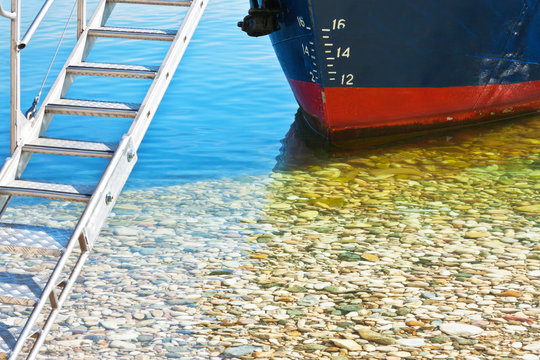 Draft marks on a ship's bow. The pleasure ship is moored on the pebble beach of Lake Baikal