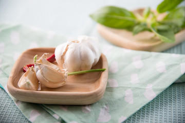 Fresh Garlic  on modern, bright wooden plate 