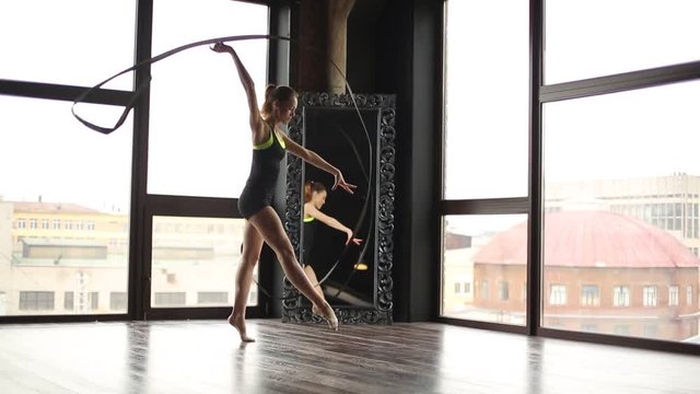 Rhythmic gymnast performs exercises with Ribbon