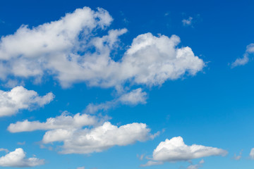 Naklejka na ściany i meble Blue sky with fluffy clouds.