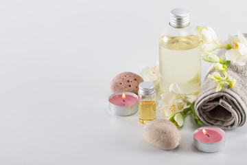 Spa concept. Aroma oil, candles, stones and flowers