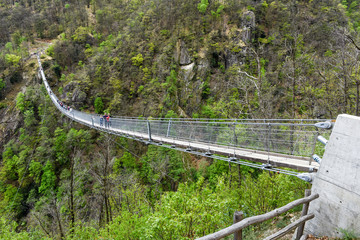 Fototapeta na wymiar The suspension bridge over the valley at Semerntina, Switzerland
