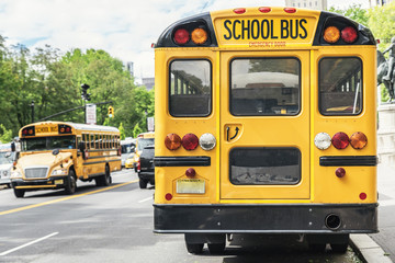 Naklejka na ściany i meble Yellow School Bus in Manhattan Streets.