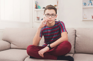 Obraz premium Teenager has phone talk in living room at home