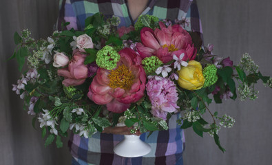 Florist holding the big beautiful bouquet in rustic style