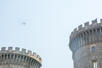 Airplane flying by a castle in Naples, Italy © Aga Rad