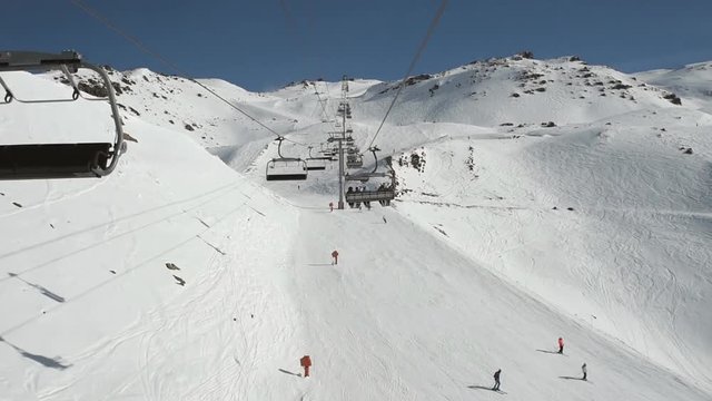 Aerial view of an alpine ski slope while traveling on chairlift