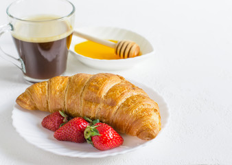 Croissant, coffee and strawberry. Summer Breakfast concept. Selective focus