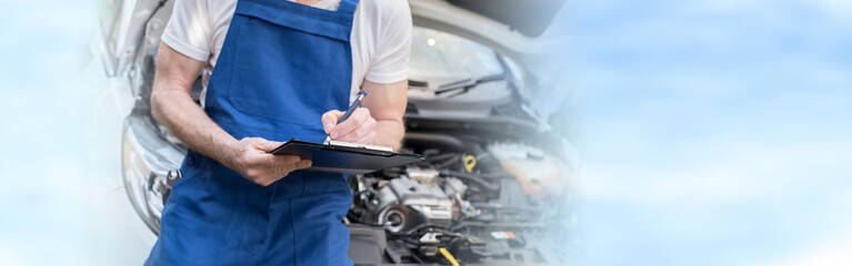 Obraz na płótnie Canvas Car mechanic checking a car engine