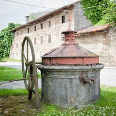Fototapeta na wymiar Old well covered with hand pump.