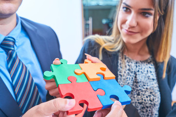 Group of business people assembling jigsaw puzzle