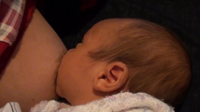 Baby suckling and swallowing with funny noises
