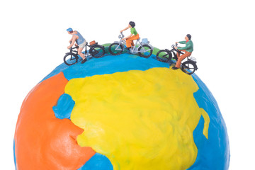 miniature people riding bicycle around the globe isolated on white background © kwanchaift
