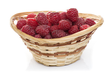 ripe raspberries in basket with mint on white