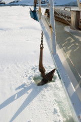 Sailing boat stuck in ice sheet in Antarctica dropping anchor 