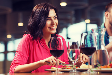 happy woman having dinner at restaurant