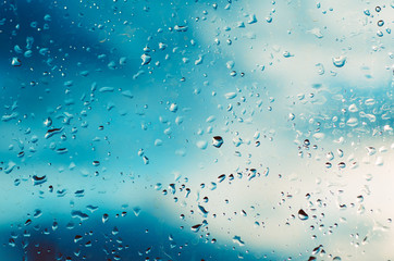 Rainy wet cold blue abstract eco seasonal natural blurred background with water drops
