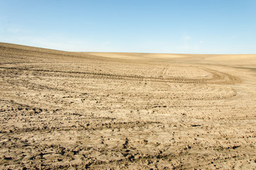 Desert. Land with reflections wheels of cars. Landscape desert. Nature wild.