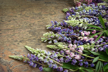 Bouquet of lupines on wooden board