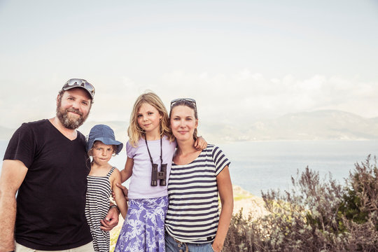 Portrait of family, near sea, smiling