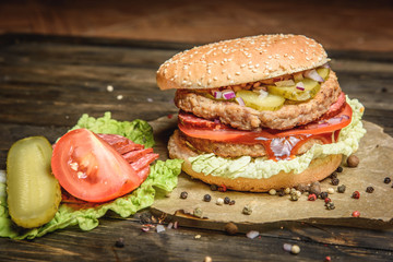 Burger with salami and vegetables