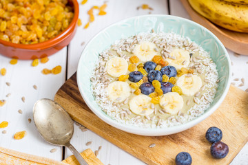 Healthy Avocado Smoothie Bowl with Blueberries, Coconut Flakes and Raisins, Horizontal View