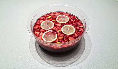 Bowl full of sangria with pieces of fruit