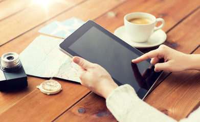 close up of traveler hands with tablet pc and map