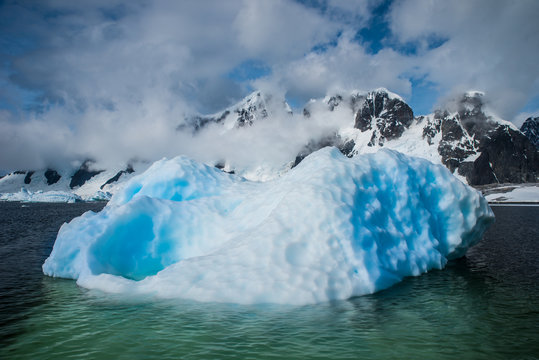 Blue shimmering beautiful iceberg in Antarctica