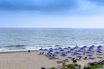 Fototapeta na wymiar Beautiful beach with sun beds and umbrellas on site