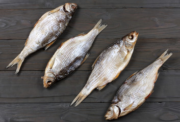 Dried fish on the table. Salty dry river fish on a dark wooden background.top view with copy space