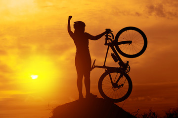 Fototapeta na wymiar Silhouettes of biker-girl at the sunset