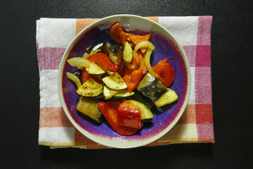 baked vegetable in a bowl on kitchen cloth