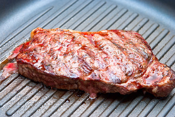 Steak grilled in a frying pan