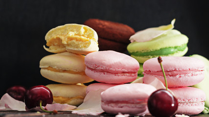 Assorted colorful macaroons. Sweet macarons on  dark background with copy space.