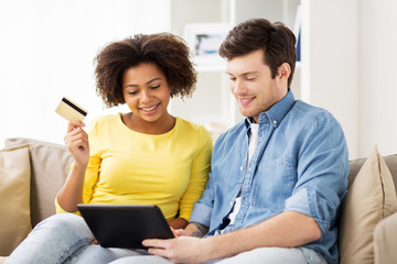 couple with tablet pc and credit card at home